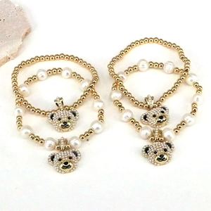 Elegant gold beads and pearl bracelets set featuring a cute micro-pave bear charm