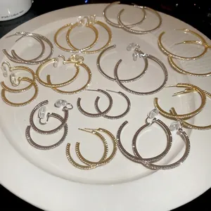 Sparkling large round hoop earrings in gold and silver finish with crystal inlay