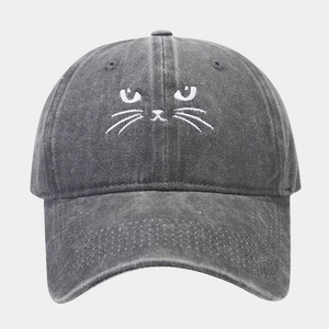 Close-up of white cat face embroidery on washed gray cotton vintage baseball cap