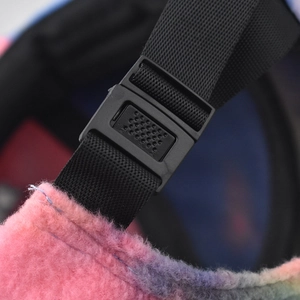 Detail of adjustable black nylon strap and plastic buckle on pink fleece baseball cap