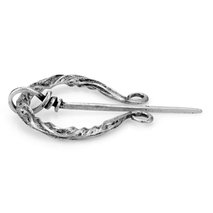 Macro shot of vintage silver Viking penannular brooch with twisted metal textures