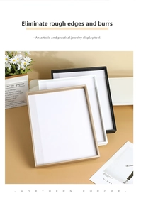 Detail of minimalist velvet jewelry display trays in black, white, and gold finishes