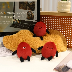 Three funny peanut plush dolls with cute expressions on a yellow sofa cushion