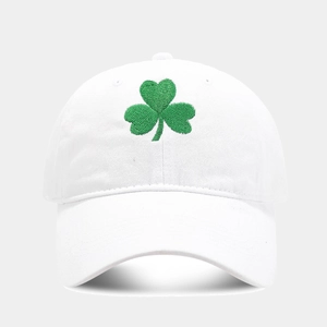 Macro detail of high-quality green shamrock embroidery on a white cotton baseball cap