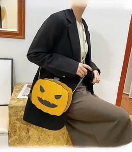 Detail view of pumpkin shaped crossbody bag with sequins and metal chain strap for Halloween