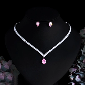 Pink teardrop gemstone necklace and earrings jewelry set displayed on model