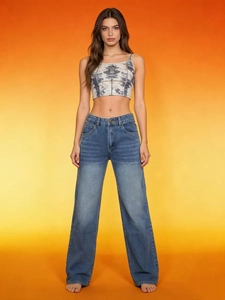 Close-up of high-waist washed blue straight-leg jeans with grey crop camisole