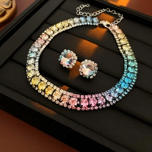 Macro shot of gradient crystal necklace and round earrings set on jewelry display