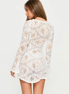 Detail of white lace crochet dress back showing slim fit and elegant texture