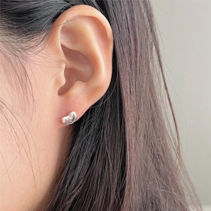 Minimalist S925 silver bean stud earring worn on ear showing high polish finish