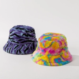 Plush faux fur bucket hats in purple zebra print and multi-color tie dye patterns