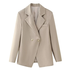 Detailed view of beige slim fit blazer with notched lapels and gold-edged buttons