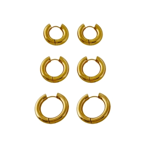 Three pairs of polished 18K gold plated chunky hoop earrings in varied sizes on white background