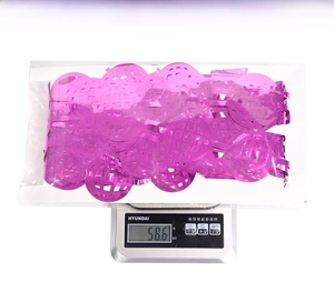 Close-up of pink disco ball foil fringe curtain in clear packaging showing 58.6g weight