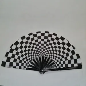 Detail shot of a black and white checkerboard folding fan with black bamboo ribs
