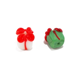 Close-up of white and green glass gift box beads for DIY jewelry making and crafts