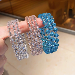 Detailed macro view of triple-layered crystal beaded ring with shimmering silver spacers