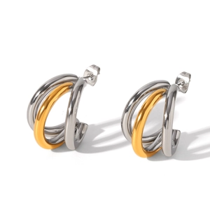 Detailed view of triple-row C-shaped earrings in two-tone gold and silver finish