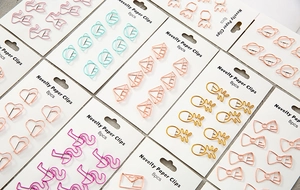 Macro shot of 8pcs novelty rose gold metal paper clips in cat and pineapple shapes