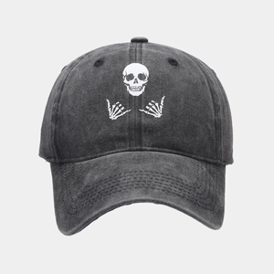 Washed dark grey baseball cap with white skull graphic and distressed vintage finish