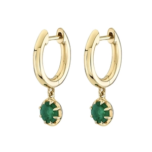 Detail of gold earrings featuring round green gemstone pendants on a white background