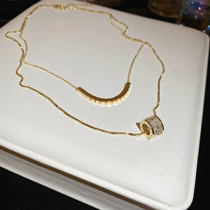 Macro shot of 18k gold plated double layer necklace with cubic zirconia pendants