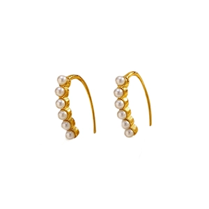 Elegant gold titanium steel hoop earrings with round white pearls on a clean white background