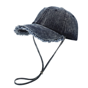 Retro denim baseball cap in washed dark blue with frayed edges and adjustable wind cord