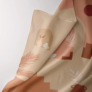 Detail of bohemian tapestry fabric showing smooth silk texture and hemmed edge craftsmanship