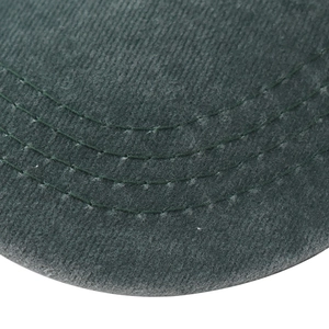 Macro detail of dark green washed baseball cap brim with triple parallel stitching