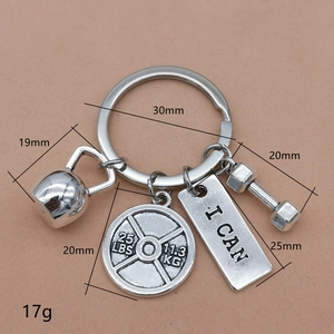 Silver fitness keychain with kettlebell, dumbbell, barbell plate and I CAN pendant charms