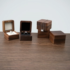 Detail of premium walnut wood jewelry boxes with plush black and white lining