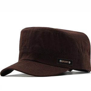 Close-up of brown military cap with SPORT leather patch and silver rivets detail