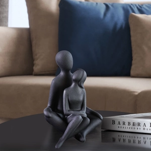 Modern ceramic embrace couple sculpture with matte black finish for minimalist home decor