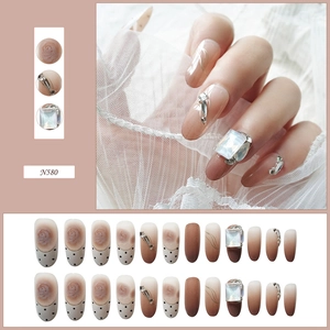 Detailed view of N580 press-on nails featuring rose patterns and square rhinestones