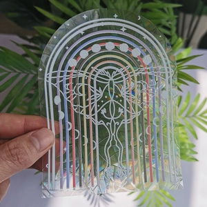 Holographic suncatcher sticker with butterfly and moon phase patterns on clear film