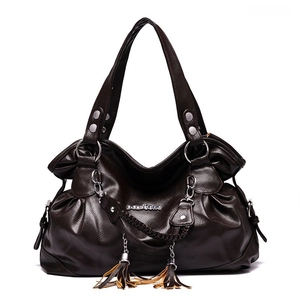 Dark brown faux leather tote bag with fringe details and metal accents on white background