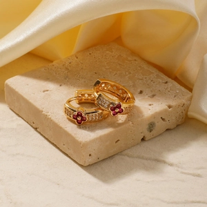 Elegant gold four-leaf flower hoop earrings with red petals and zircon stones