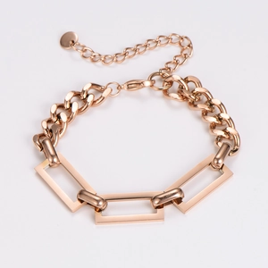 Detail view of rose gold splice bracelet with geometric blocks and thick link chain texture