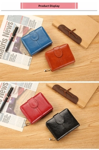 Short vintage oil-wax leather wallets in four colors displayed on a retro desk setup