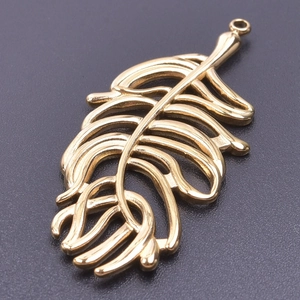Close-up of 18k gold plated stainless steel leaf charm with hollowed-out detail