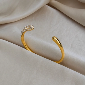 Luxurious 18K gold plated stainless steel open bangle featuring pave set zircons
