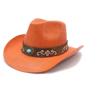 Close-up of orange woven straw cowboy hat with embroidered faux leather band and turquoise stone