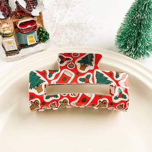 Vue détaillée de la pince à cheveux de Noël rouge avec motifs renne et sapin