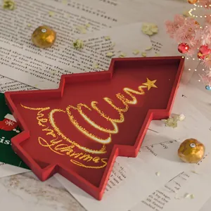 Christmas tree shaped red resin tray with gold Merry Christmas lettering on holiday decor