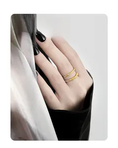Detail of two-piece silver and gold rings with textured surface and small diamonds