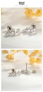Macro view of geometric zircon stud earrings showing screw-back and marquise cut details