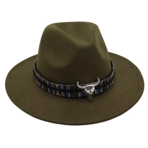 Close-up of olive green wool fedora hat featuring ethnic woven band and silver bull head charm