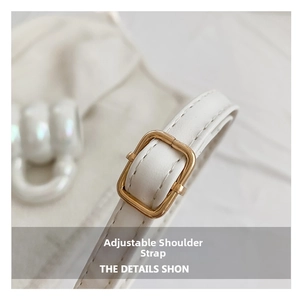 Detail of white leather shoulder strap with adjustable gold square metal buckle