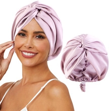 Detail of lavender satin turban featuring a braided twist design and elastic back fit